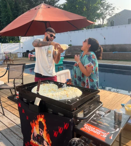 Hibachi chef interacting with guests during an at-home backyard hibachi experience in California