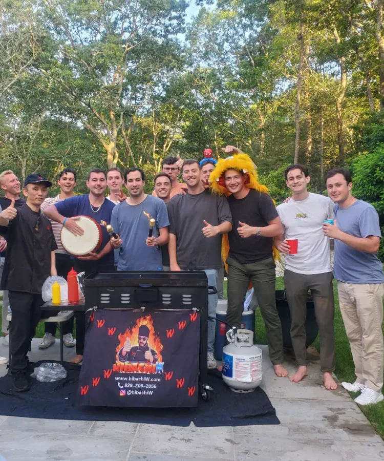 Group of guests enjoying an outdoor at-home hibachi dining experience in Clearwater