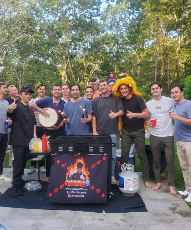 Friends enjoying a small group hibachi at home dinner in a backyard in Connecticut