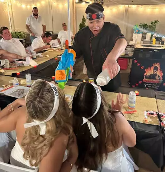 hibachi at home airbnb delaware – chef performing water and sake spray show