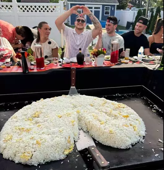 hibachi at home airbnb rhode island – chef cooking fried rice at the table