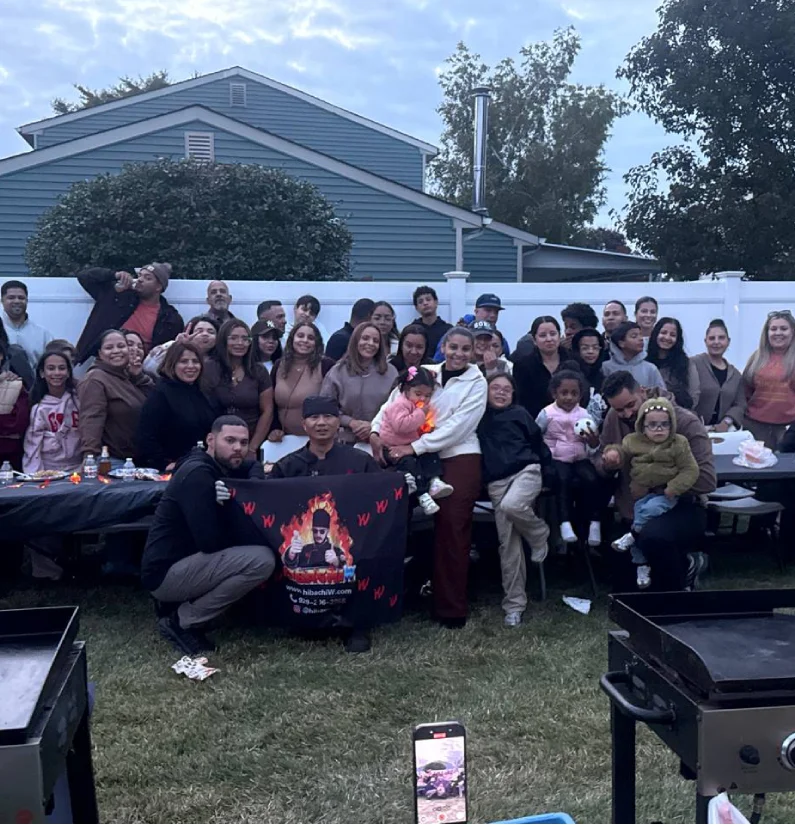 Large group hibachi dinner setup at home with a mobile chef